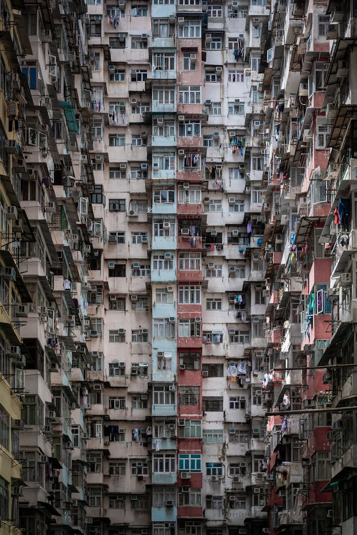 A dramatic view of crowded, towering apartment buildings in Hong Kong, showcasing urban density.